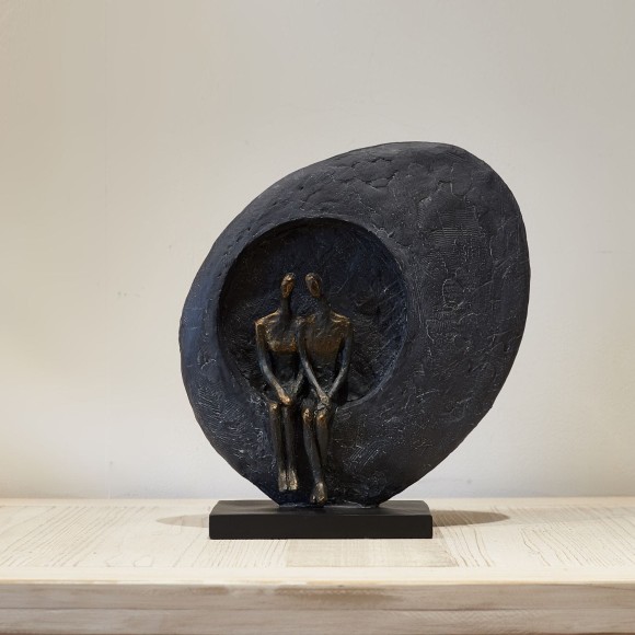 A bronze couple sculpture, a sculpture with an abstract design made from bronze and resin