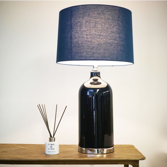 Blue lamp on table next to a diffuser