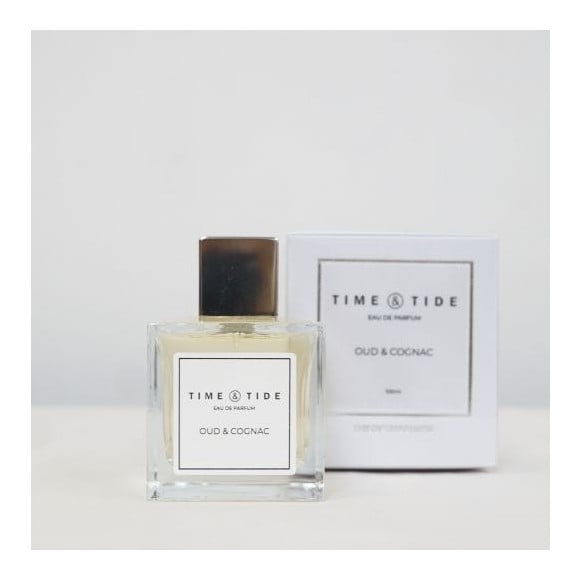 A premium oud eau de parfum in glass square perfume bottle, beside a white perfume box