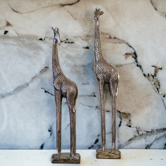 A set of small and large decorative giraffes in metallic silver finish