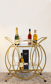 gold bar trolley with bottles displayed on it 