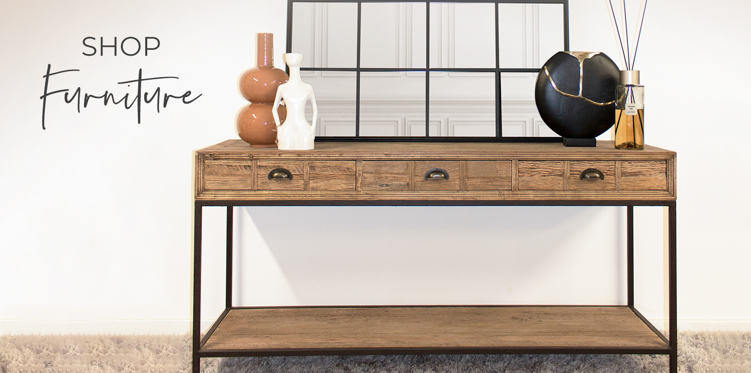 A 3 drawer wooden console table with black legs, with a black grid mirror atop