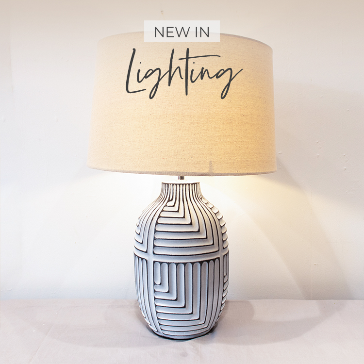 A white table lamp with abstract pattern, complete with neutral linen shade
