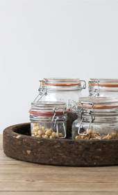 four kilner jars in cork tray on table