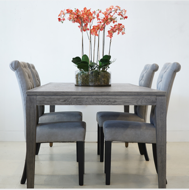 Grey Oak Dining Table with 4 dining chairs and an orchid on tabletop