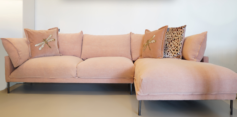 pink linen l-shape sofa with blush dragonfly cushions on top