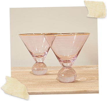 two pink martini glasses with gold rim
