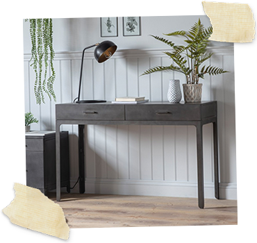 grey 2 drawer desk with desk lamp and plant