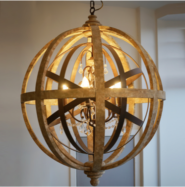 wood and iron globe chandelier hanging from ceiling with suspended glass crystals
