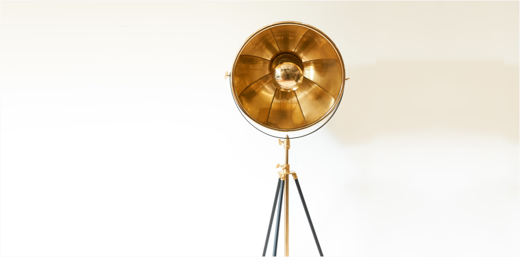 gold and black spotlight tripod lamp