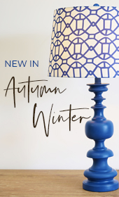 blue carved lamp with white and blue pattern shade with text stating "New In Autumn/Winter"