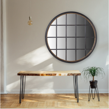 Round black grid mirror with gold detailing to inner frame