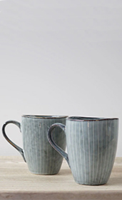 Pale Nordic mugs with no handle on table