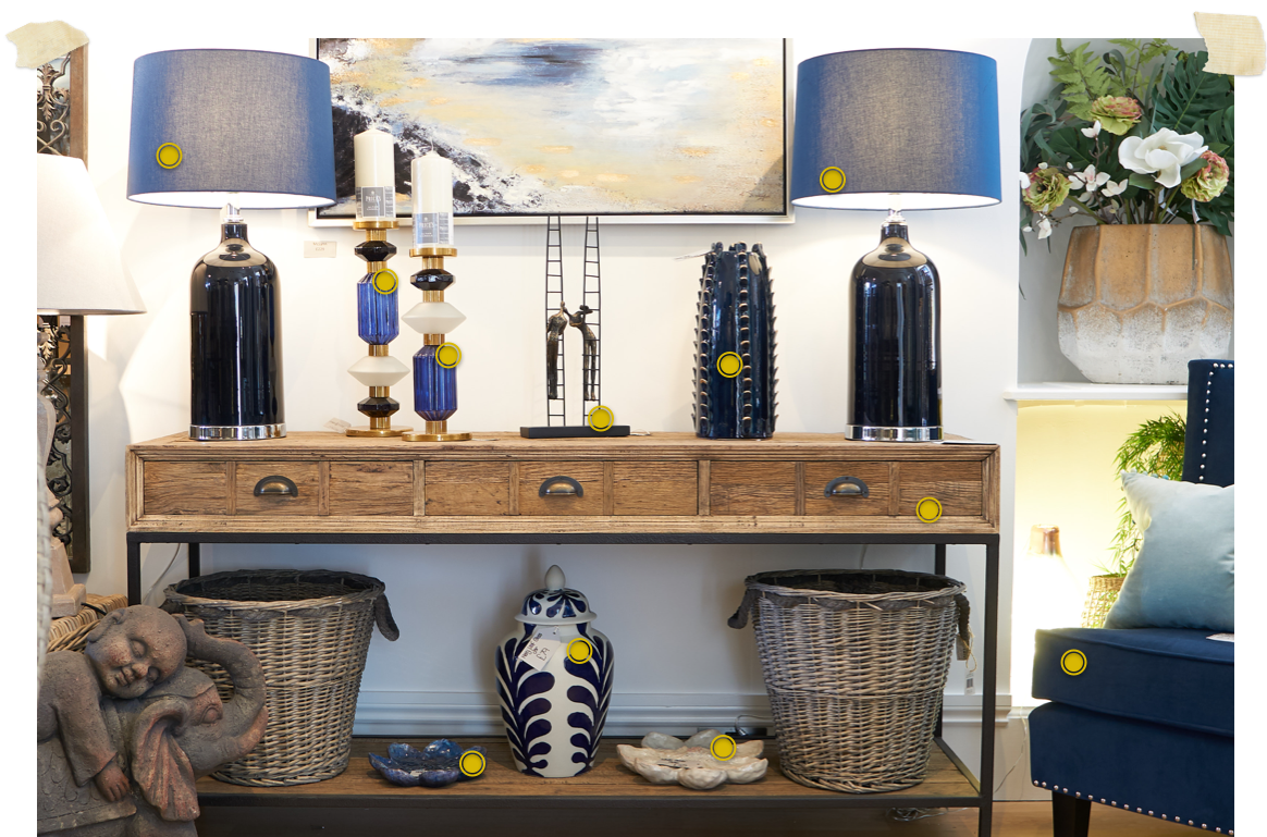 wooden 3 drawer console with navy lamps and interior accessories