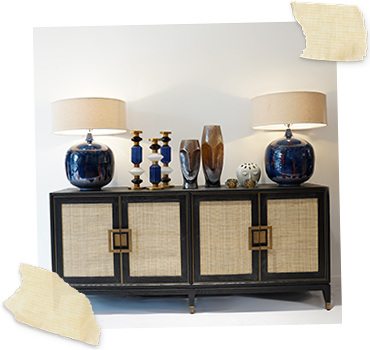 Black rattan sideboard with blue gloss lamps and sculptural vases