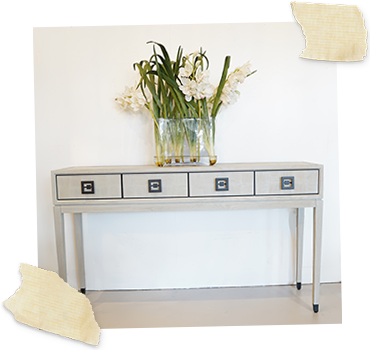 White oak 4 drawer console table with white orchid in centre