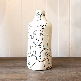 a monochrome vase with linear face motifs